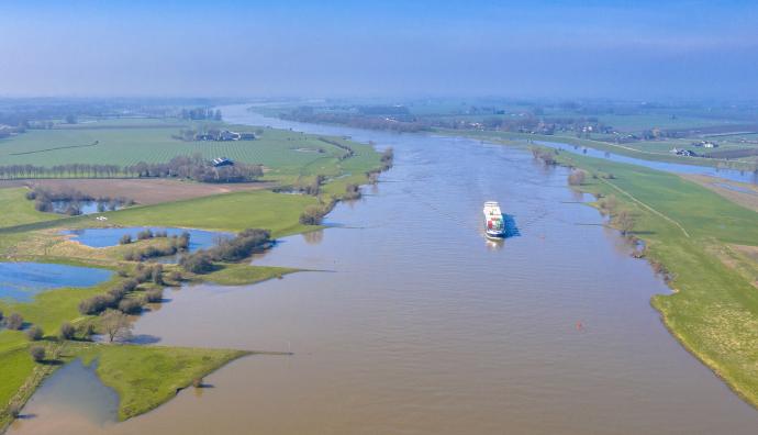 Container ship on river in landscape | Seacon Logistics